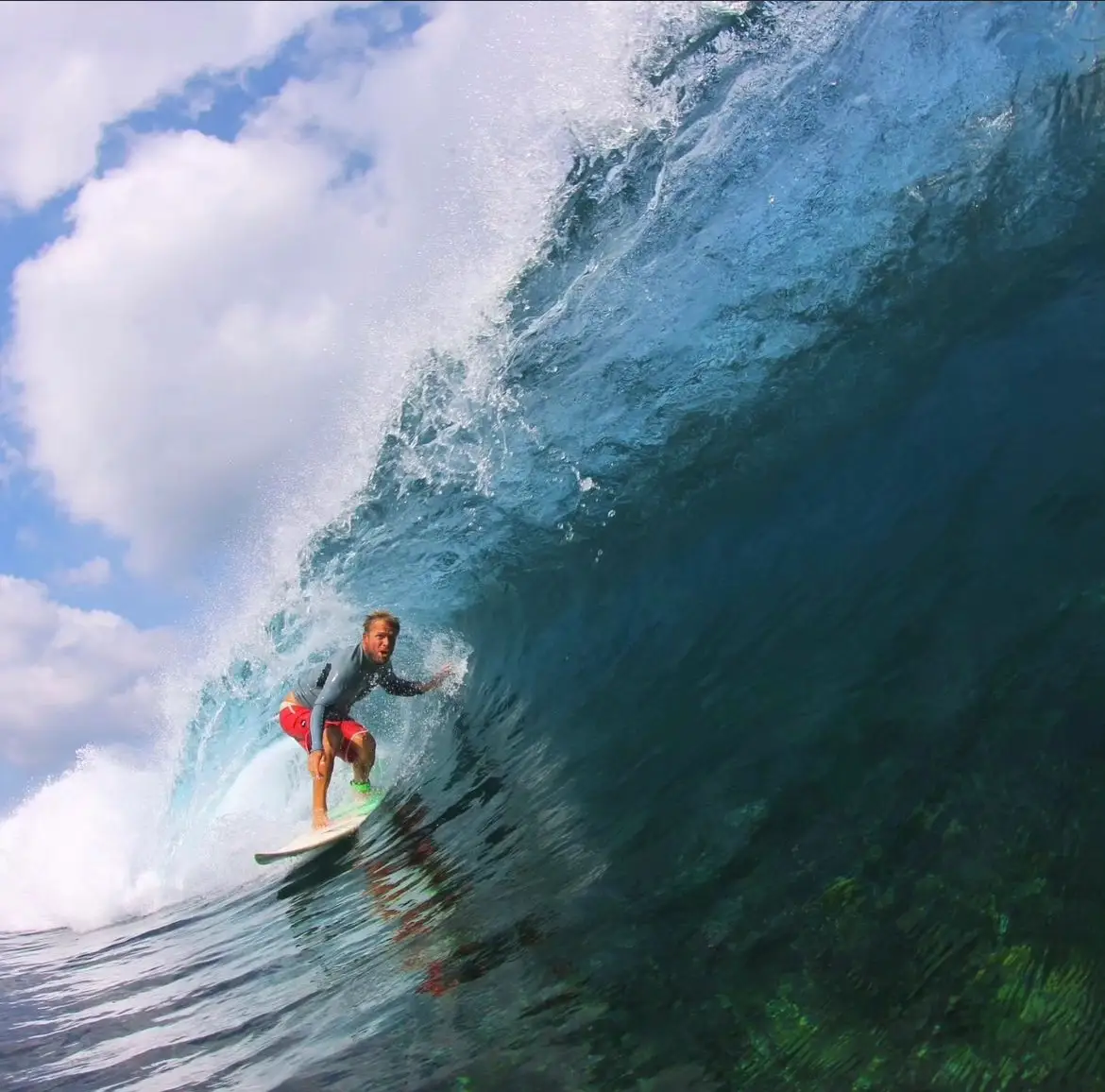 Surfer inside a glassy barrel over shallow reef at Lance's Right