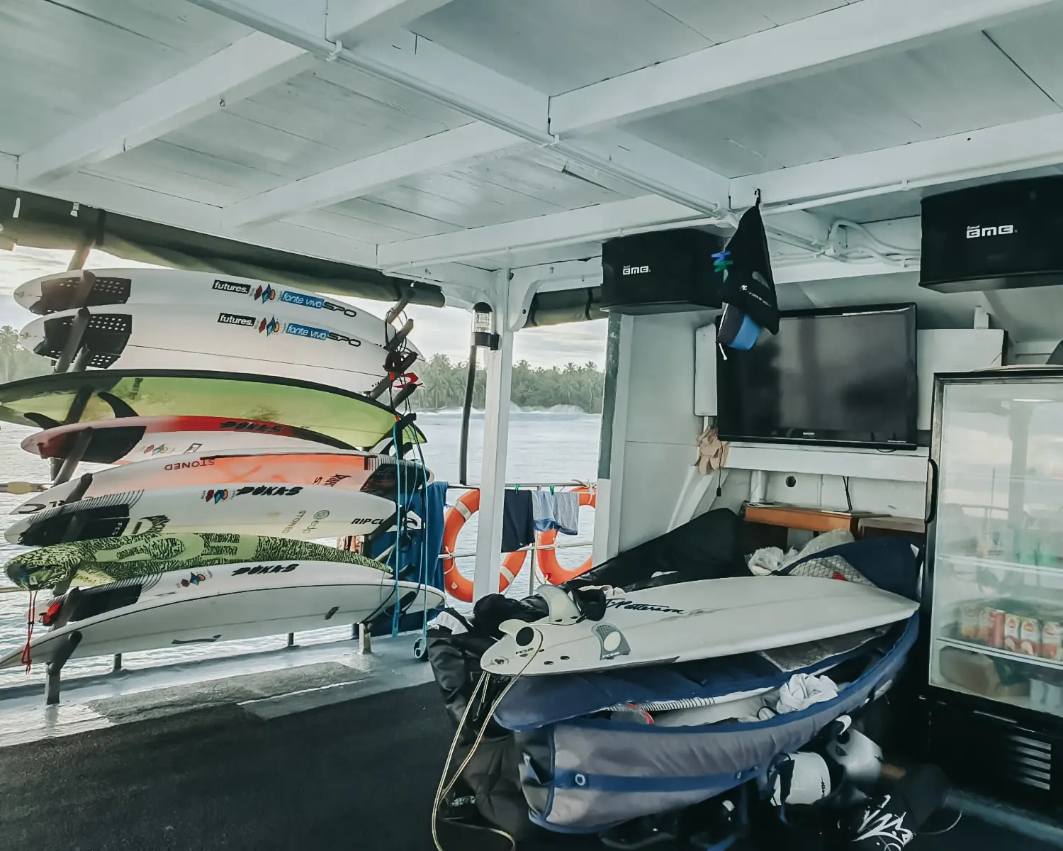 Surfboard rack stacked with boards on the covered deck