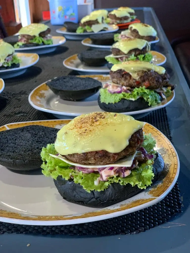 Plated burgers lined up on the galley table