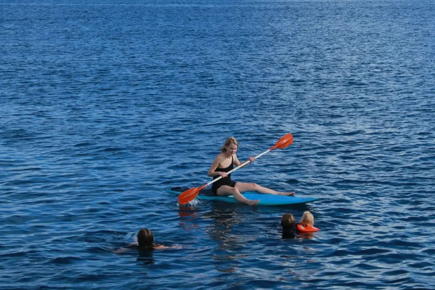 Kayak and swimmers off the boat on a rest day